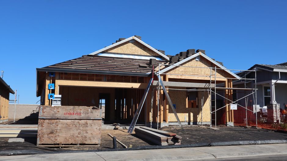 New suburban house under construction, showcasing modern architectural design.